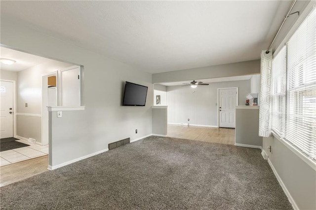 7201 E 130th Ter, Grandview, MO 64030 - unfurnished living room with carpet flooring and ceiling fan