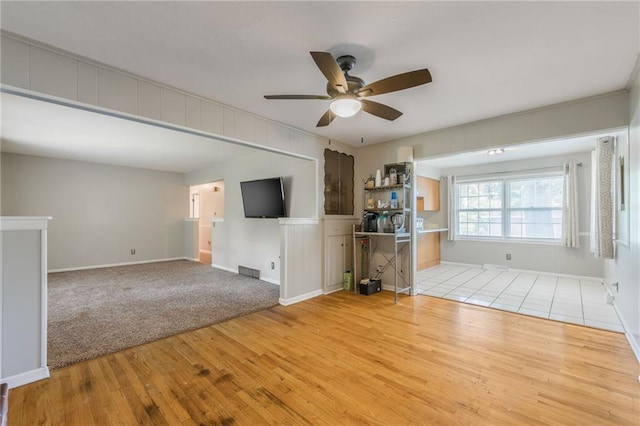 7201 E 130th Ter, Grandview, MO 64030 - unfurnished living room featuring light wood finished floors and ceiling fan