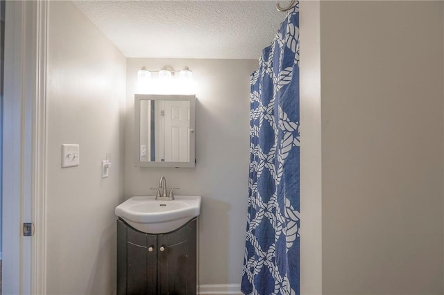 bathroom with vanity and a textured ceiling