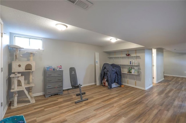 interior space featuring visible vents, baseboards, and wood finished floors