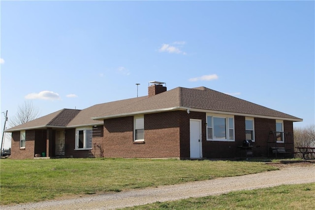 16468 K 16 Hwy, Oskaloosa, KS 66066 - view of front facade featuring a chimney, brick siding, and a front lawn