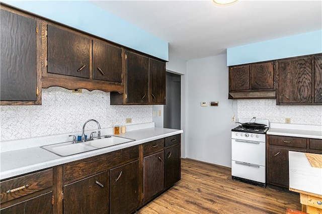 16468 K 16 Hwy, Oskaloosa, KS 66066 - kitchen featuring white gas stove, a sink, backsplash, light countertops, and dark brown cabinets