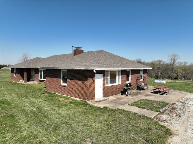 16468 K 16 Hwy, Oskaloosa, KS 66066 - back of property with a yard, brick siding, and a patio