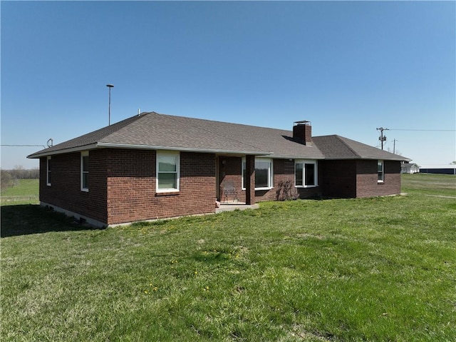 16468 K 16 Hwy, Oskaloosa, KS 66066 - rear view of property with brick siding, a lawn, a chimney, and a shingled roof