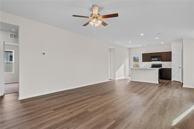 37854 W 207th Ter, Edgerton, KS 66021 - unfurnished living room featuring dark wood-style floors, a ceiling fan, and recessed lighting