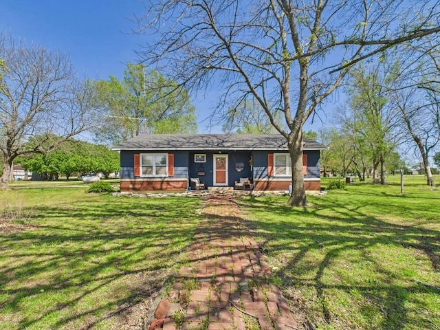view of front of home featuring covered porch and a front yard