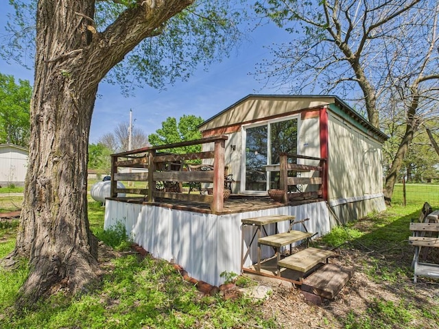 back of property with a wooden deck
