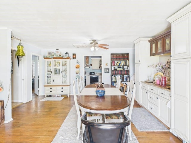 dining area featuring ceiling fan and light wood-style flooring
