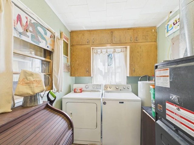 washroom featuring crown molding, water heater, laundry area, and washer and dryer