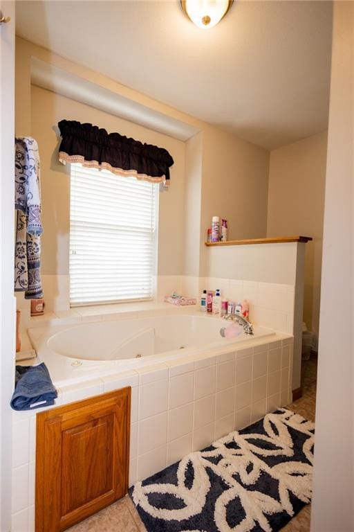 11295 County Road 366, Savannah, MO 64485 - bathroom featuring a tub with jets and tile patterned flooring