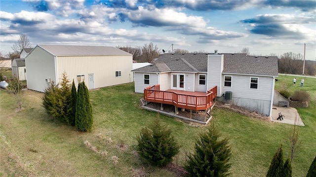 11295 County Road 366, Savannah, MO 64485 - back of house featuring a wooden deck, an outbuilding, central AC unit, and a lawn