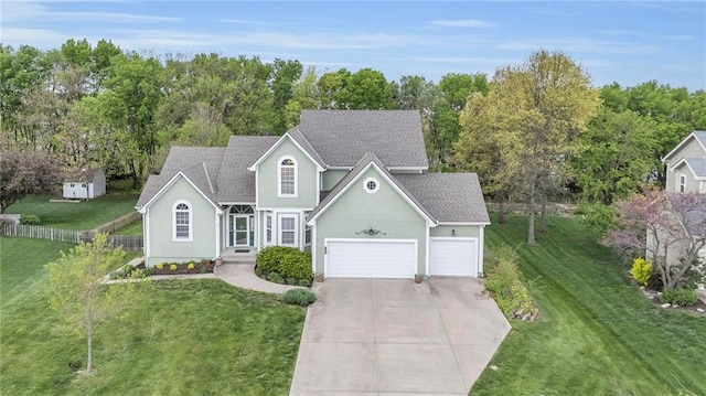 traditional-style home with roof with shingles, stucco siding, driveway, and a garage