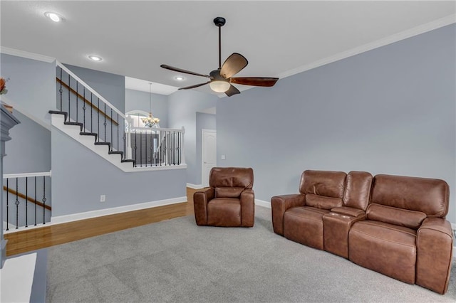 carpeted living room with ornamental molding, stairs, baseboards, recessed lighting, and ceiling fan with notable chandelier