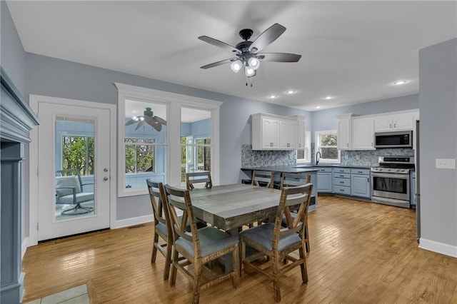 dining room featuring baseboards, a ceiling fan, recessed lighting, and light wood-style flooring