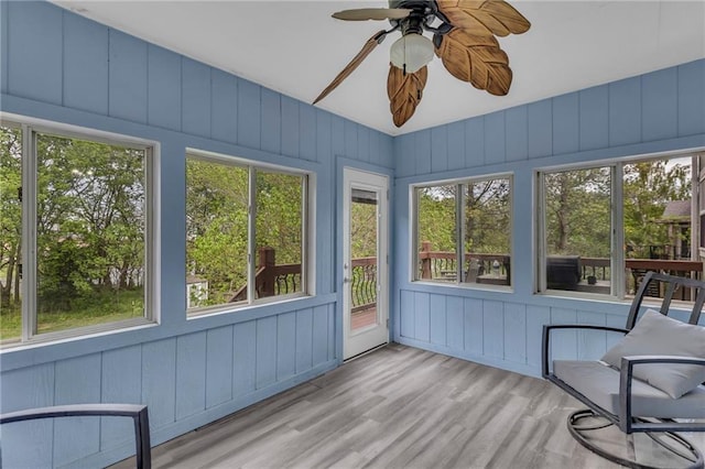 unfurnished sunroom featuring a wooden deck and wood finished floors
