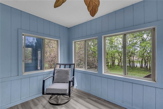 sunroom / solarium featuring a healthy amount of sunlight and wood finished floors