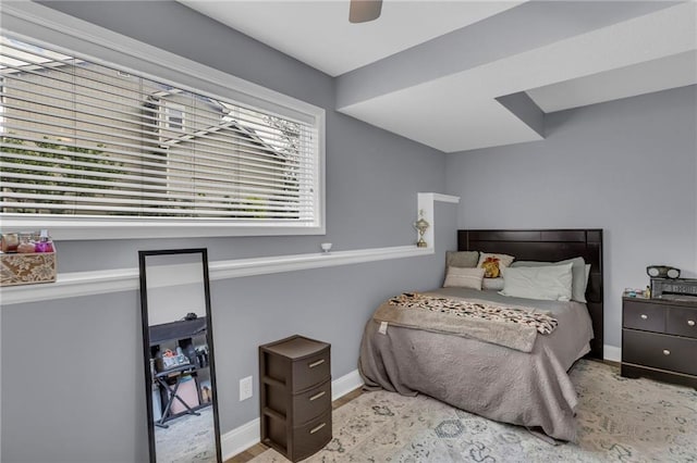 bedroom featuring baseboards and ceiling fan