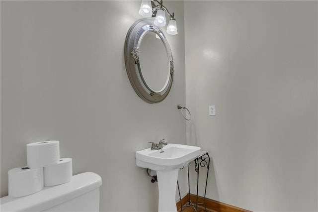 half bath featuring a sink and toilet