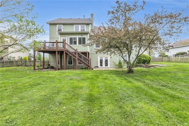 back of house with a fenced backyard, a wooden deck, french doors, and stairway