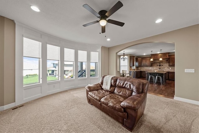11194 S Hastings St, Olathe, KS 66061 - carpeted living room featuring visible vents, arched walkways, baseboards, and recessed lighting