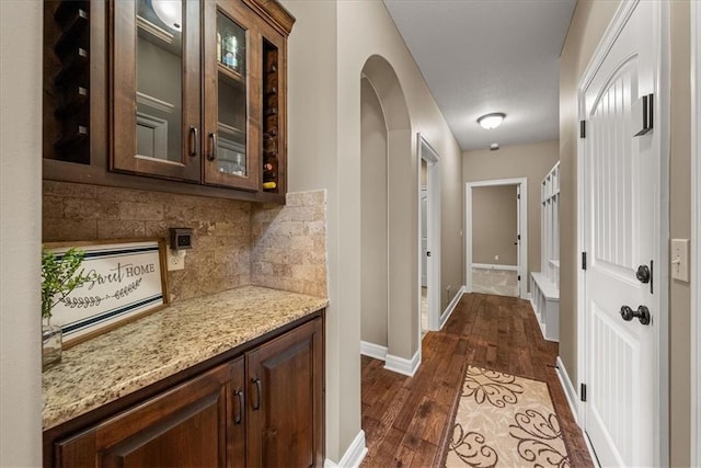 11194 S Hastings St, Olathe, KS 66061 - hallway with dark wood-style flooring, arched walkways, and baseboards