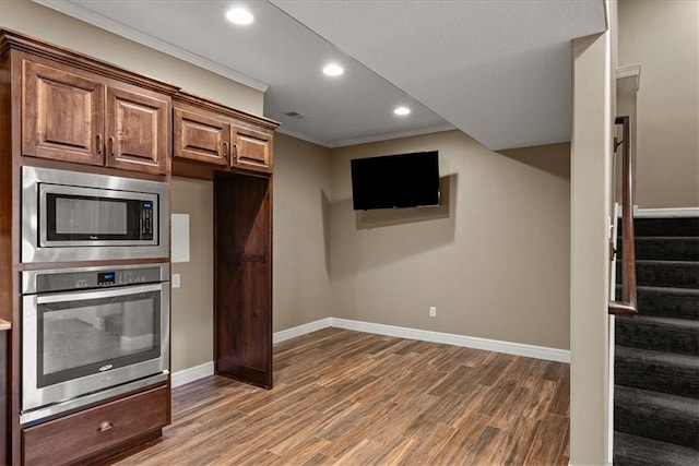 11194 S Hastings St, Olathe, KS 66061 - kitchen featuring crown molding, wood finished floors, baseboards, stainless steel appliances, and recessed lighting
