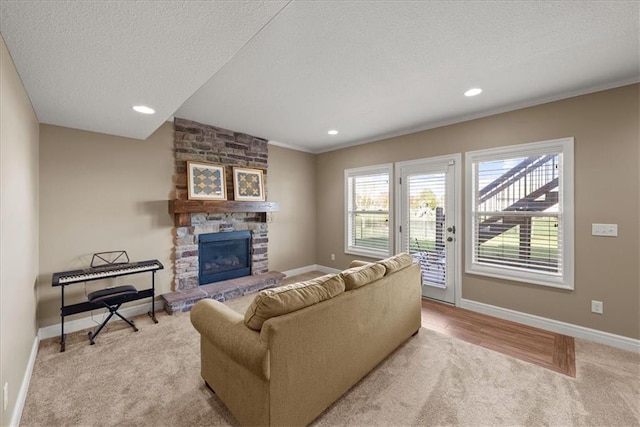 11194 S Hastings St, Olathe, KS 66061 - living room with light colored carpet, ornamental molding, baseboards, and a stone fireplace
