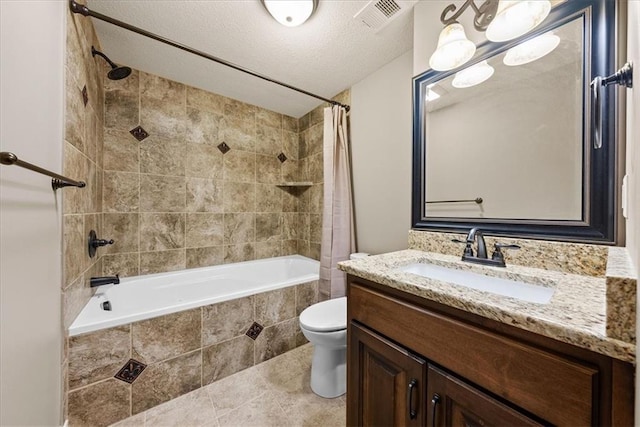 11194 S Hastings St, Olathe, KS 66061 - bathroom with visible vents, vanity, tiled shower / bath, tile patterned floors, and toilet