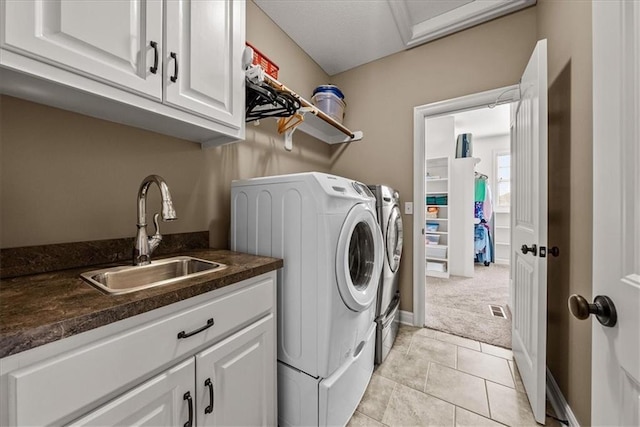 11194 S Hastings St, Olathe, KS 66061 - laundry room featuring washing machine and clothes dryer, cabinet space, a sink, light tile patterned floors, and light carpet