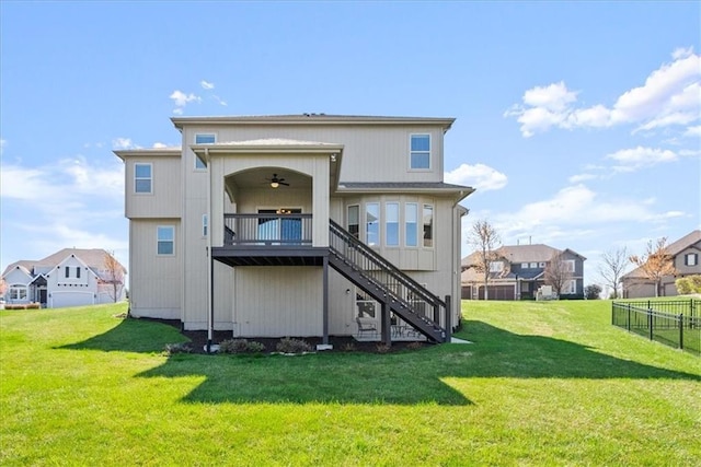 11194 S Hastings St, Olathe, KS 66061 - back of house featuring stairs, a ceiling fan, a lawn, and fence