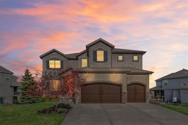 11194 S Hastings St, Olathe, KS 66061 - view of front of home featuring stone siding, a garage, stucco siding, a yard, and driveway