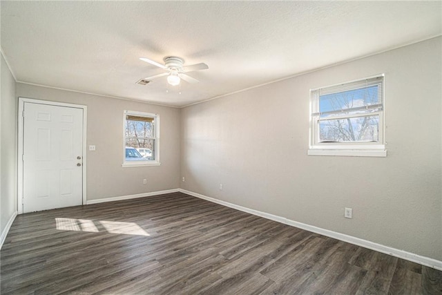 3552 S Lynn St, Independence, MO 64055 - empty room with baseboards, visible vents, ceiling fan, and dark wood-type flooring
