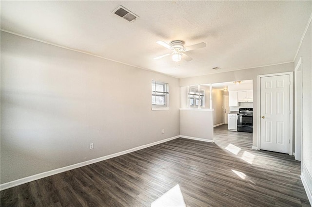 3552 S Lynn St, Independence, MO 64055 - unfurnished room with a ceiling fan, dark wood-style flooring, baseboards, and visible vents