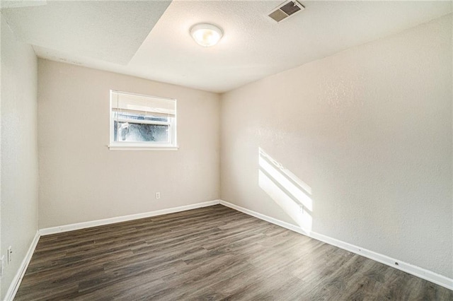 3552 S Lynn St, Independence, MO 64055 - spare room featuring dark wood-style flooring and baseboards