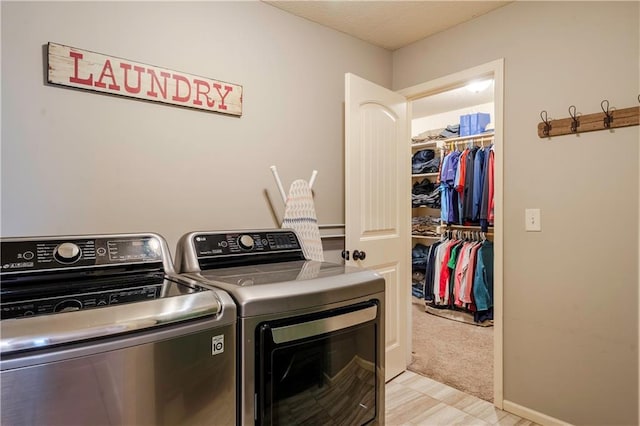 washroom with separate washer and dryer and laundry area