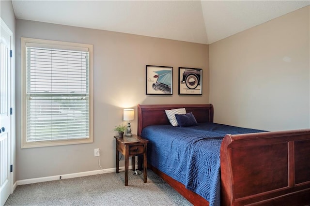 bedroom featuring baseboards, carpet, and vaulted ceiling