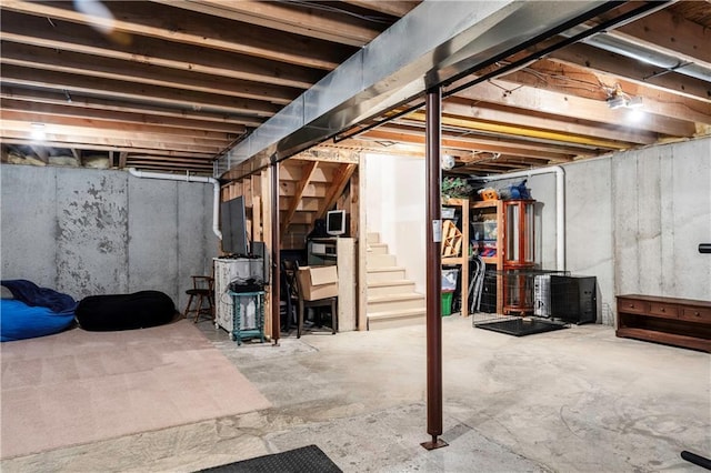 unfinished basement featuring stairway