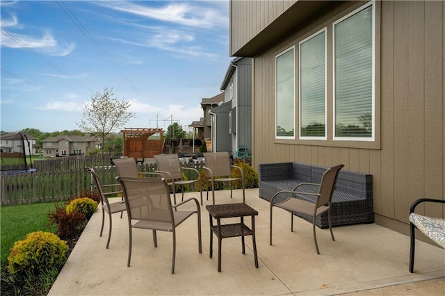 view of patio / terrace with fence and a trampoline