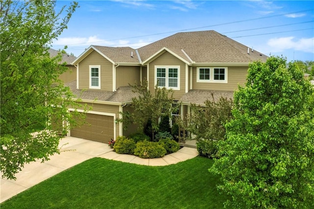 view of front of home featuring concrete driveway, a shingled roof, a front lawn, and a garage