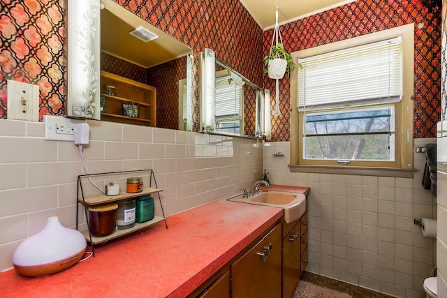 bathroom with tile walls, wallpapered walls, visible vents, and vanity