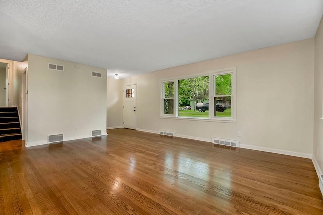 unfurnished living room featuring visible vents