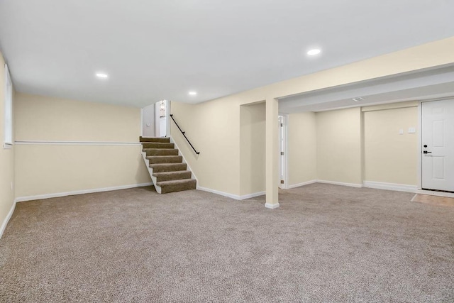finished basement featuring baseboards, carpet flooring, recessed lighting, and stairs
