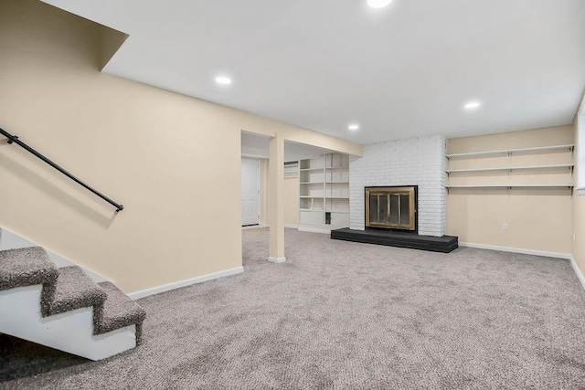 unfurnished living room featuring baseboards, a brick fireplace, recessed lighting, and carpet floors