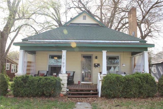 view of front of house with a porch and a shingled roof