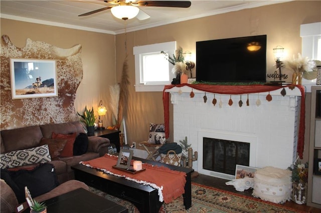 living room featuring a fireplace, ornamental molding, and ceiling fan
