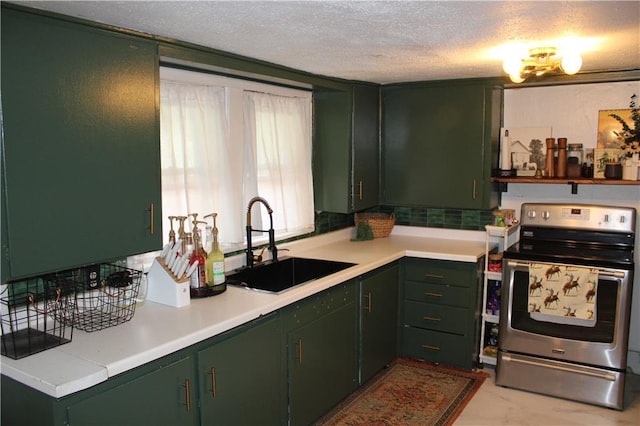 kitchen with a textured ceiling, light countertops, electric stove, a sink, and green cabinetry