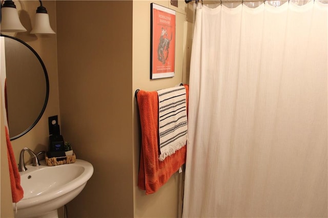 full bathroom with a sink and curtained shower