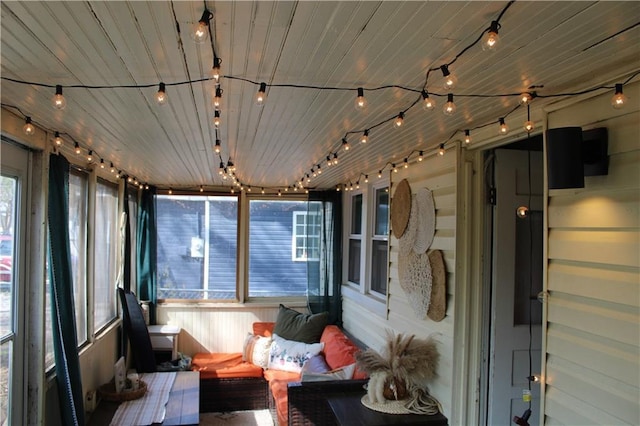 sunroom / solarium with wooden ceiling and track lighting
