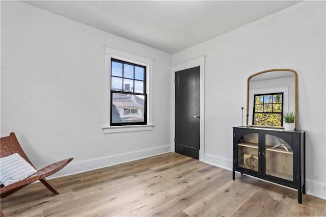 unfurnished room featuring wood finished floors and baseboards