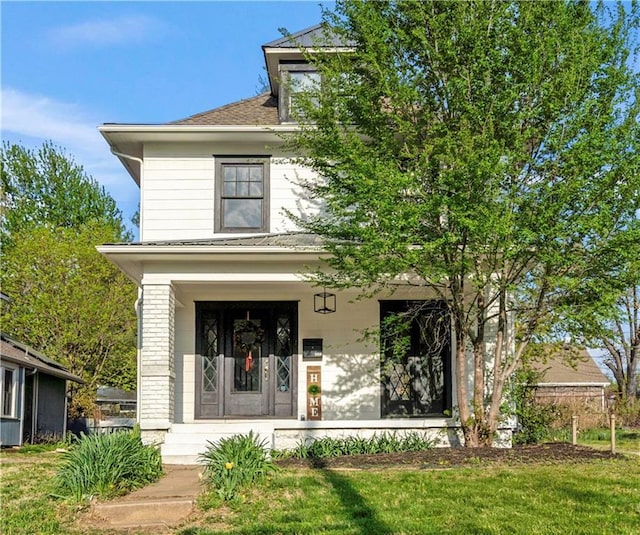 exterior space featuring a porch and a front yard